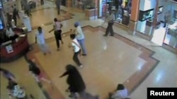 FILE - Shoppers flee during an attack by gunmen, inside the Westgate shopping mall in this still frame taken from video footage by security cameras inside the mall in Nairobi, Kenya, released on Oct. 17, 2013.
