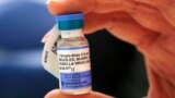 FILE - A nurse holds a vial of measles, mumps and rubella vaccine at Boston Children's Hospital in Boston, Mass., Feb. 26, 2015. 