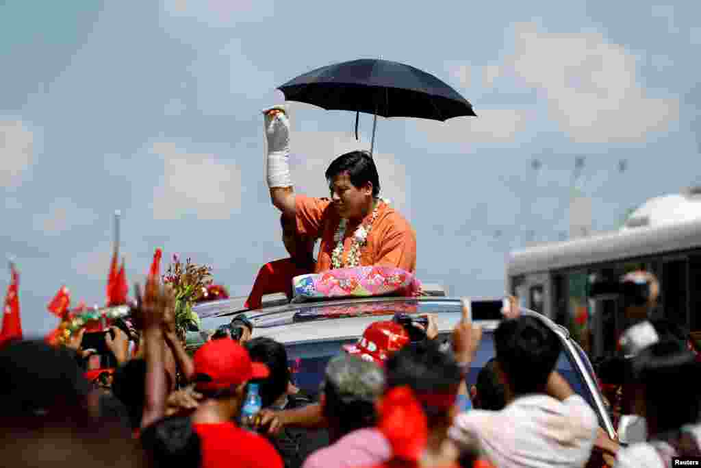 Candidate Naing Nan Lynn, who was attacked last week while campaigning, waves during National League for Democracy (NLD) party campaign rally in Yangon, Myanmar.