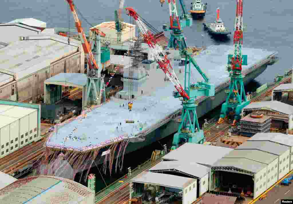 An aerial view of Japan Maritime Self-Defense Force's new helicopter destroyer, DDH183 Izumo, is seen at its launching ceremony in Yokohama, south of Tokyo, August 6, 2013.