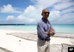 President Barack Obama looks stands at Turtle Beach to speak to the media as he tours Midway Atoll in the Papahanaumokuakea Marine National Monument, Northwestern Hawaiian Islands.