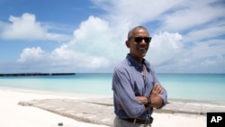 President Barack Obama looks stands at Turtle Beach to speak to the media as he tours Midway Atoll in the Papahanaumokuakea Marine National Monument, Northwestern Hawaiian Islands.