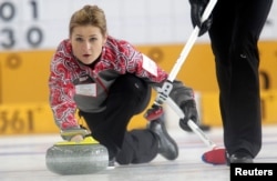 FILE - Russia's second Margarita Fomina watches a stone during their World Women's Curling Championship qualification round match against Japan in Riga, March 20, 2013.