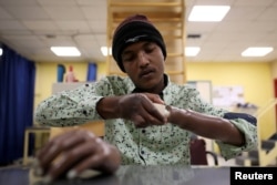 War-wounded Abdullah Ayed, 21 year-old man from Yemen, tries his 3D-printed prosthetic limb at the MSF-run hospital in Amman, Jordan, Feb. 27, 2019.