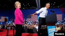 President Barack Obama points to Democratic presidential candidate Hillary Clinton during a Clinton campaign event in Charlotte, North Carolina, July 5, 2016. 