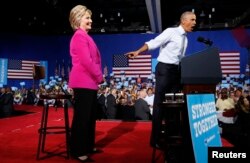 President Barack Obama points to Democratic presidential candidate Hillary Clinton during a Clinton campaign event in Charlotte, North Carolina, July 5, 2016.