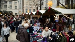 Shoppers look for gifts in booths set up for the holidays around City Hall in Philadelphia, Dec. 8, 2016.