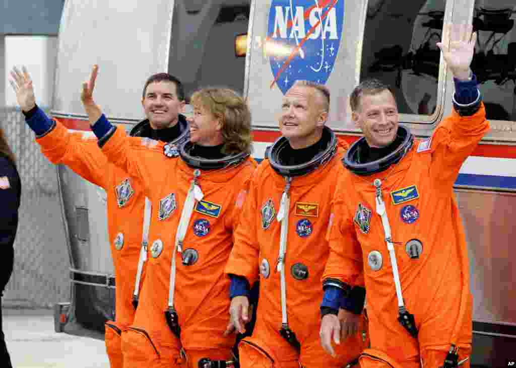 July 8: The space shuttle Atlantis astronauts left to right, mission specialists Rex Walheim, Sandy Magnus, pilot Doug Hurley and commander Chris Ferguson, leave the operations and check-out building on the way to the pad at the Kennedy Space Center. (AP 