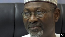 FILE - Independent National Electoral Commission (INEC) Chairman Attahiru Jega displays the timetable. 
