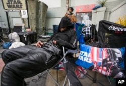 FILE – Fans camp out while waiting for the premiere of "Star Wars: The Force Awakens" in Los Angeles, Dec. 9, 2015.