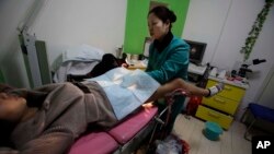 In this 2010 file photo, a nurse examines a patient at an abortion clinic run by Marie Stopes International in Xi'an in central China's Shaanxi province. (AP Photo/Ng Han Guan)