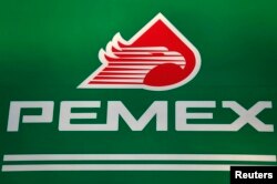 FILE - The logo of Mexican state-owned oil company Pemex is seen at a Mexico City gas station.
