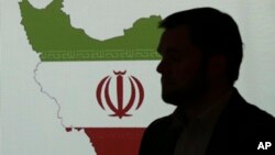 Stuart Davis, a director at one of FireEye's subsidiaries, stands in front of a map of Iran as he speaks to journalists about the techniques of Iranian hacking, Sept. 20, 2017, in Dubai, United Arab Emirates. 