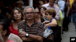 People line up to check for their signatures at data center outside of the Venezuelan National Electoral Council, CNE, headquarters, in Caracas, June 20, 2016.