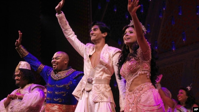 This image released by Disney Theatrical Productions shows, from second left, Michael James Scott as Genie, Michael Maliakel as Aladdin, and Shoba Narayan as Jasmine after a performance of the Broadway musical