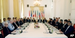 Delegates participate in a bilateral meeting as part of the closed-door nuclear talks with Iran at a hotel in Vienna, Austria, June 12, 2015.