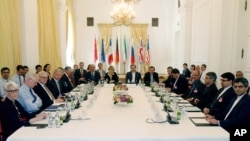 Delegates particpate in a bilateral meeting as part of the closed-door nuclear talks with Iran at a hotel in Vienna, Austria, June 12, 2015.