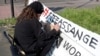 A protester writes his sign outside HMP Belmarsh prison where WikiLeaks founder Julian Assange is held, in London, Britain, April 15, 2019.