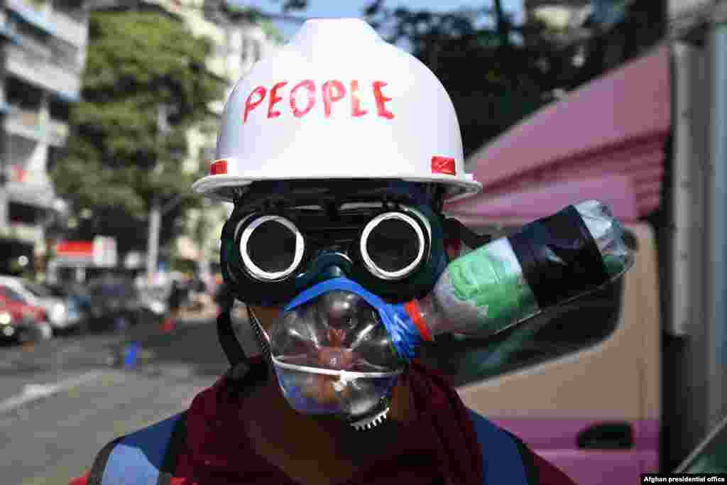 A protester wearing an improvised tear gas protection gear looks on during a demonstration against the military coup in Yangon, Myanmar.
