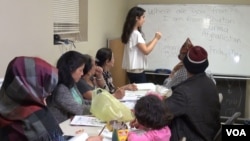 Refugees living in an apartment complex in Maryland study English as a way to get comfortable living in the U.S.