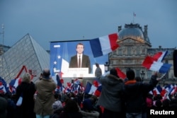 President-elect Emmanuel Macron is seen on a giant screen near the Louvre museum after results were announced in the second round of voting in the 2017 French presidential elections, in Paris, France, May 7, 2017.