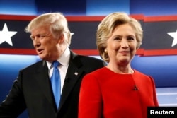 Republican U.S. presidential nominee Donald Trump and Democratic U.S. presidential nominee Hillary Clinton greet one another as they take the stage for their first debate at Hofstra University in Hempstead, New York, Sept. 26, 2016.