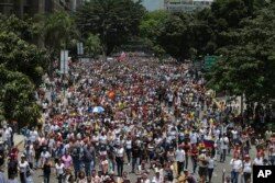 FILE - Opposition marchers protest the Maduro government in Caracas April 10, 2017. Massive pro- and anti-government demonstrations are planned for Wednesday in Venezuela.