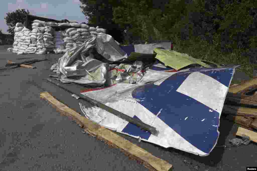 Wreckage lies near a pro-Russian separatist checkpoint at the site of the downed Malaysian airliner MH17 near the village of Rozsypne, in the Donetsk region, Aug. 4, 2014.