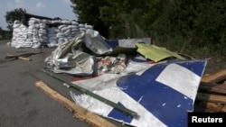 Wreckage lies near a pro-Russian separatist checkpoint at the site of the downed Malaysian airliner MH17 near the village of Rozsypne in the Donetsk region August 4, 2014.