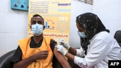 A medical worker receives a dose of the Oxford-AstraZeneca COVID-19 coronavirus vaccine at the Jabra Hospital for Emergency and Injuries in Sudan's capital Khartoum on March 9, 2021. - Sudan is the first in the Middle East and North Africa to receive vaccines through COVAX, a UN-