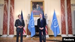 US Secretary of State Antony Blinken poses with International Atomic Energy Agency Director General Rafael Mariano Grossi in the Benjamin Franklin Room ahead of a meeting at the State Department in Washington, D.C., Oct. 18, 2021.