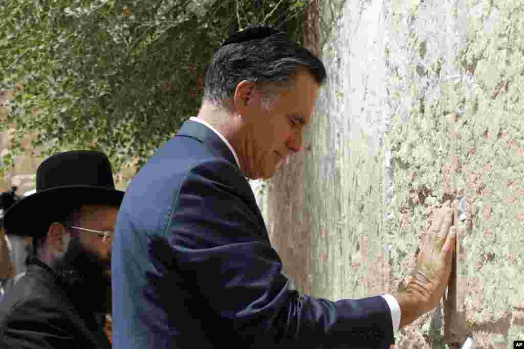 Republican presidential candidate Mitt Romney pauses as he visits the Western Wall in Jerusalem, July 29, 2012.