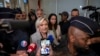 French far-right leader Marine Le Pen is flanked by police officers as she arrives at the court house in Paris, Sept. 30, 2024. 