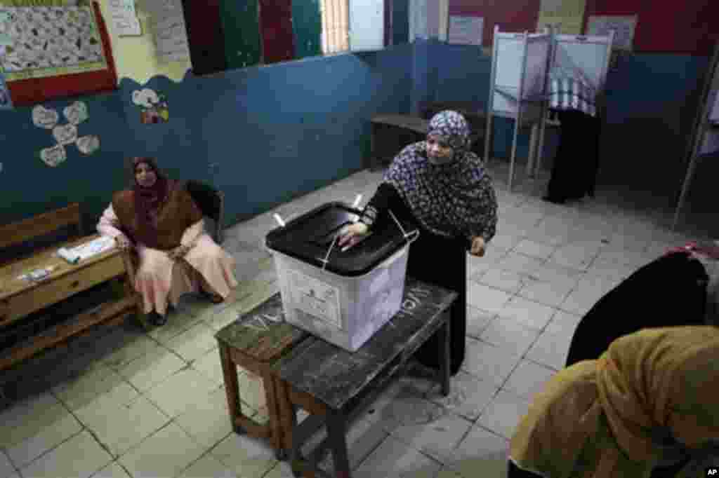 An Egyptian woman casts her vote inside a polling station in Cairo, Egypt, Thursday, May 24, 2012. In a wide-open race that will define the nation's future political course, Egyptians voted Thursday on the second day of a landmark presidential election th