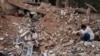 Lina Rida Jawhari cries as she sits amid the rubble of her family's destroyed house in Baalbek, Lebanon, on Nov. 28, 2024.