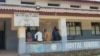 Men sit outside the general hospital in Basankusu, Democratic Republic of Congo, where some victims of unidentified illnesses are being treated, Feb. 27, 2025.