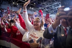 Members of the audience wave and cheer as President Donald Trump speaks at a rally at BancorpSouth Arena in Tupelo, Miss., Nov. 1, 2019.