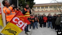 Rail workers talk to colleagues outside the Saint Charles station in Marseille, southern France, April 3, 2018.