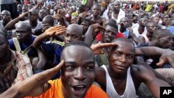 Youth supporters of Ivory Coast's Laurent Gbagbo gather at a stadium at army headquarters to sign up for military service in Abidjan, March 21, 2011