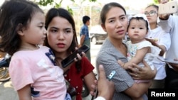 Families of jailed Reuters reporters Wa Lone and Kyaw Soe Oo talk to the media after attending a hearing at Myanmar's Supreme Court in Naypyitaw, Myanmar, March 26, 2019.