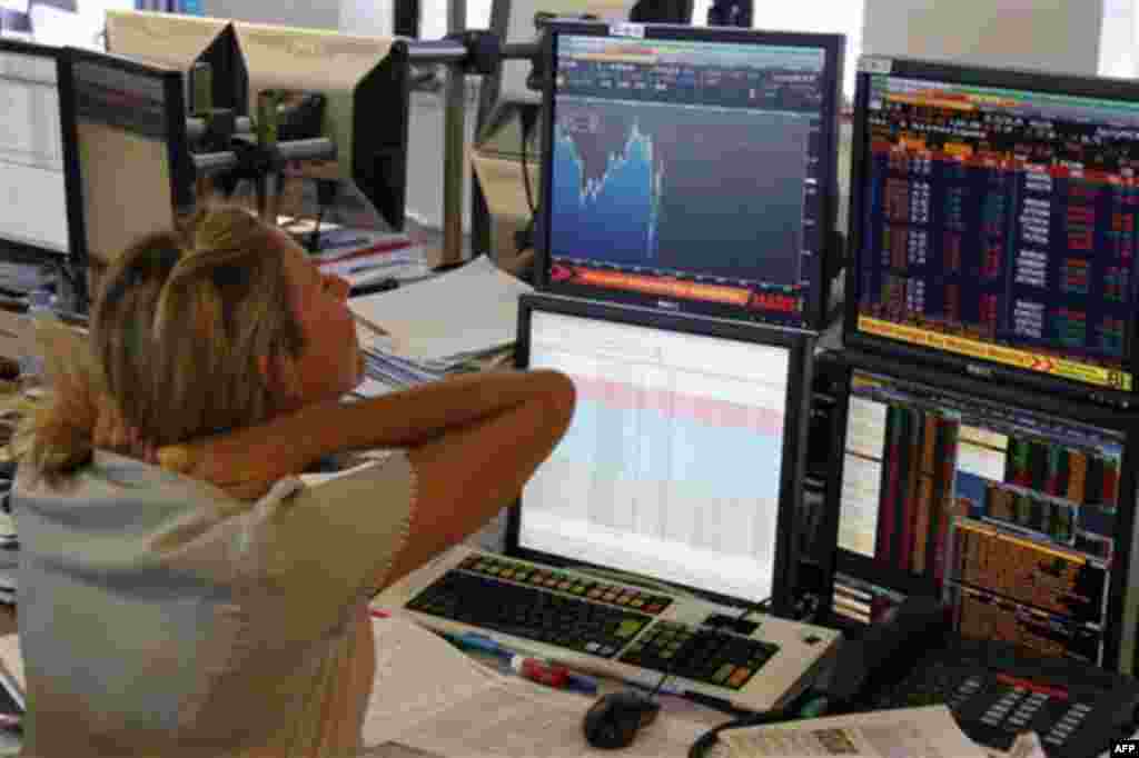 A trader looks at a graph displaying activity on the French Stock Exchange, in Paris, Wednesday, Aug. 17, 2011. The leaders of France and Germany called Tuesday for greater economic discipline and unity among European nations but declined to take immediat