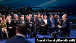 RUSSIA -- Russian President Vladimir Putin, right, speaks to his supporters during a campaign appearance in Moscow, Russia, Tuesday, Jan. 30, 2018