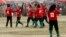 FILE - The Afghan national women's soccer team celebrates a victory in a friendly match against a women's team from the NATO-led International Security Assistance Force in Kabul, Oct. 29, 2010.