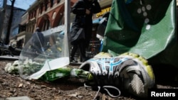 FILE - A running shoe with flowers lies near the site of the second bomb blast in the 2013 Boston Marathon bombings in Boston, Massachusetts, April 16, 2014. 