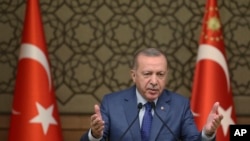 FILE - Turkish President Recep Tayyip Erdogan speaks at the presidential palace in Ankara, Turkey, Oct. 24, 2019. 