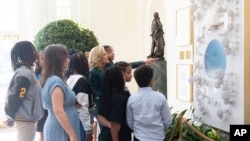 First lady Jill Biden talks to a group of students in the Booksellers Hall on the day of the unveiling of the new enhanced White House public tour, in Washington, Oct. 21, 2024.