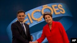 Kandidat Presiden Brazil dari Partai Pekerja Dilma Rousseff, kanan, dan saingannya Aecio Neves, dari Partai Sosial Demokrasi Brazil, berjabat tangan sebum memulai debat mereka, di Rio de Janeiro, Brazil, Jumat, 24 Oktober 2014. (AP Photo/Silvia Izquierdo)