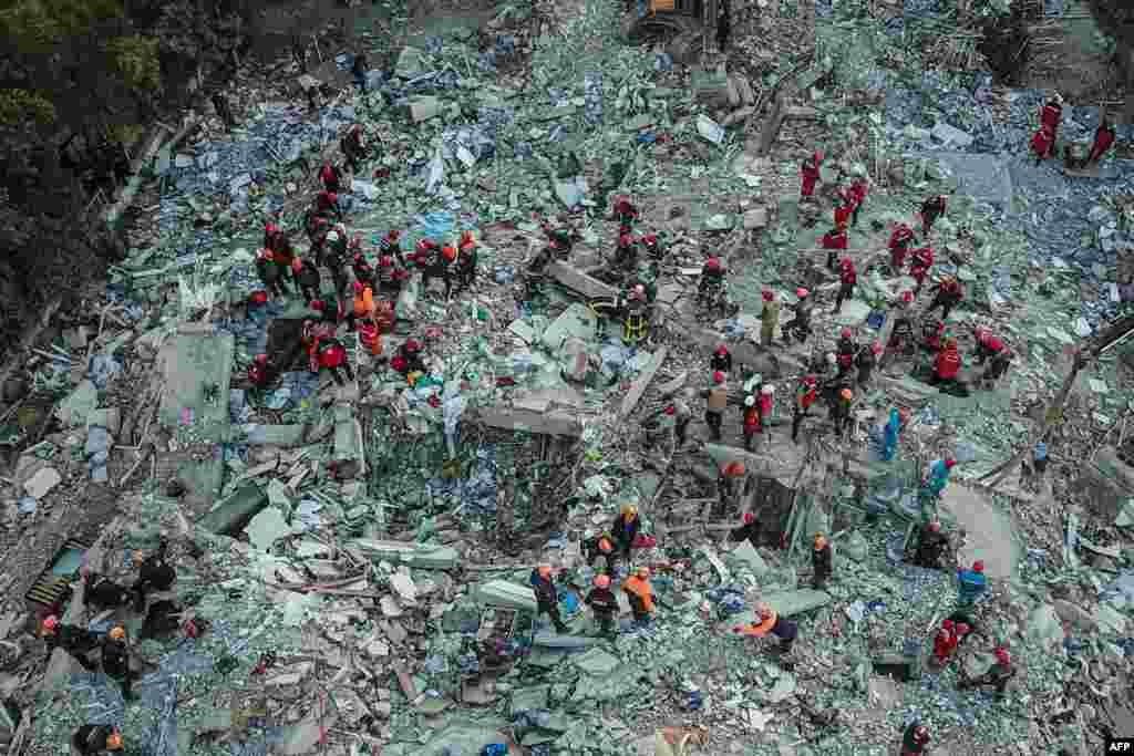 An aerial view taken on Oct. 31, 2020, shows rescue workers searching for survivors in a collapsed building in Izmir, after a powerful earthquake struck Turkey&#39;s western coast and parts of Greece.