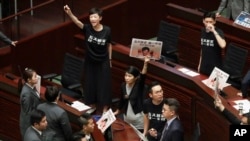 Pro-democracy lawmakers protest as Chief Executive Carrie Lam delivers a speech in Hong Kong, Oct. 16, 2019. Chanting pro-democracy lawmakers have interrupted the start of a speech that Lam was giving laying out her policies.