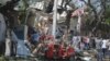 People gather at the scene of an explosion outside a restaurant in Mogadishu, March 28, 2019.